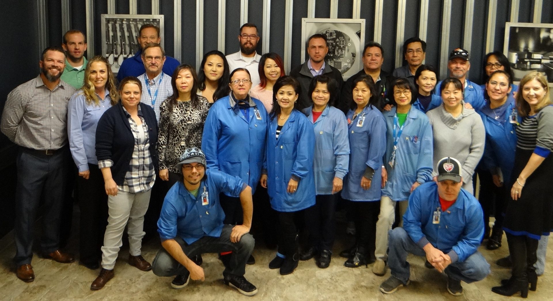 group photo of Advanced Assembly employees in blue jackets